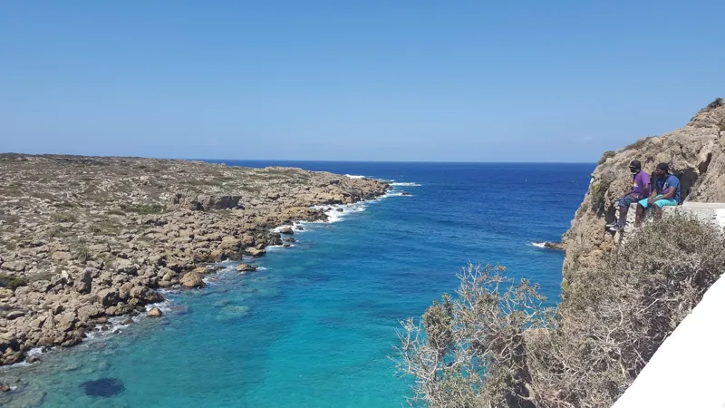 A narrow blue cove bordered by rocky coast