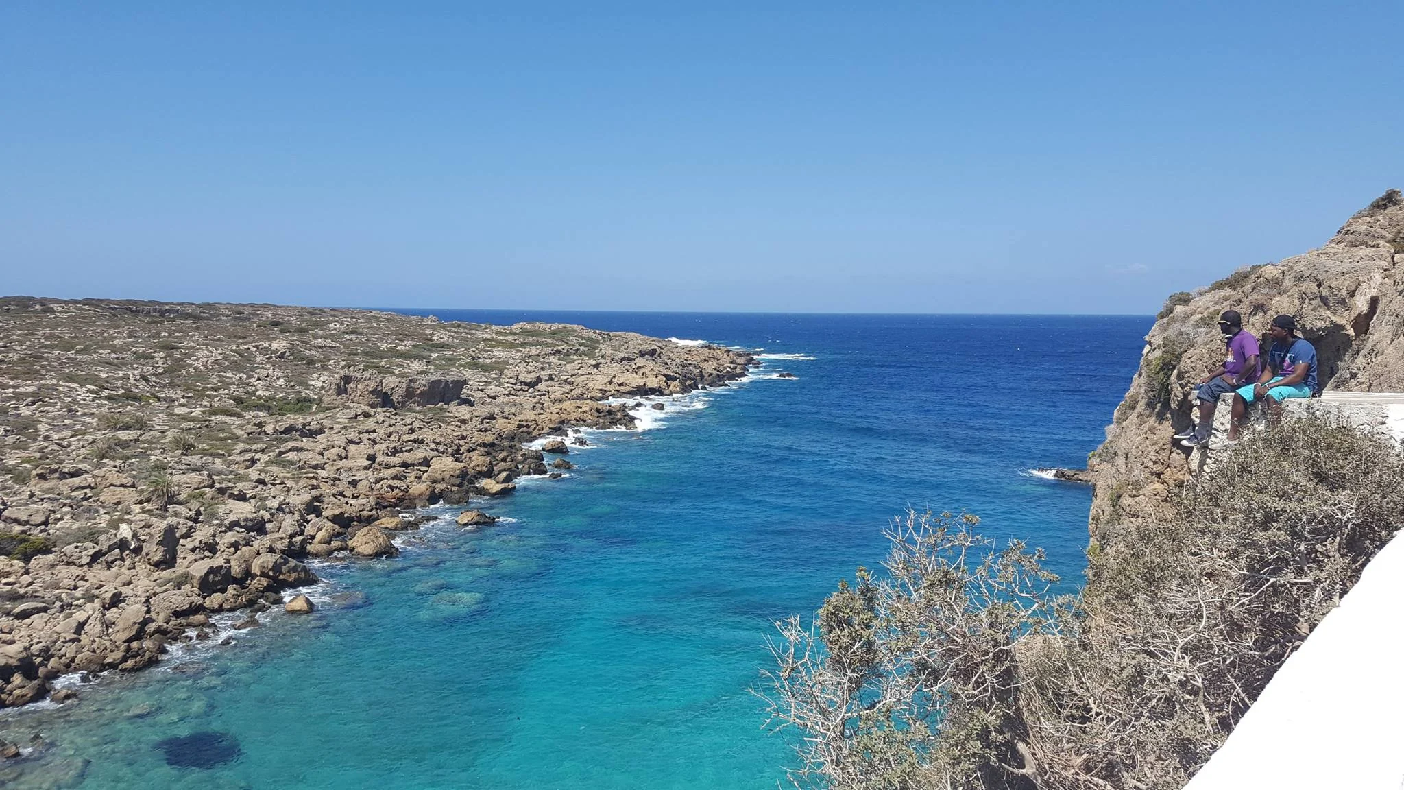 A narrow blue cove bordered by rocky coast