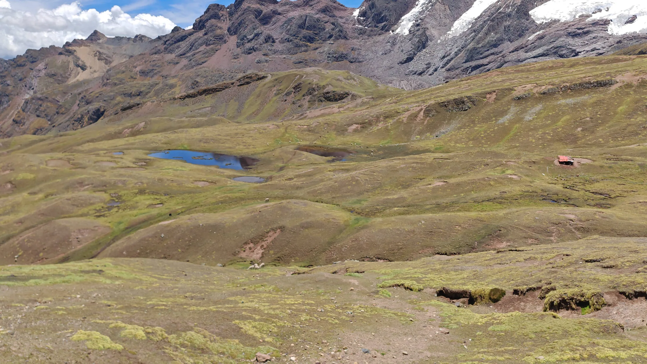 A small blue lake among high Andean slopes