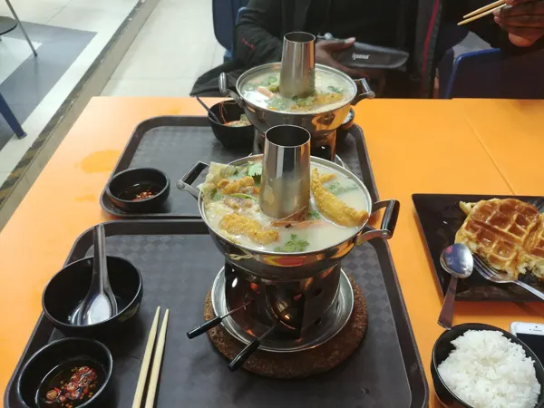 Hot pots and rice set out for a shared meal