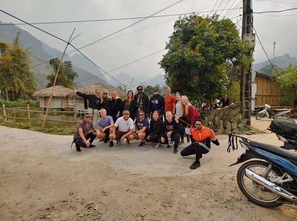 A group of travellers beside a northern Vietnam mountain road