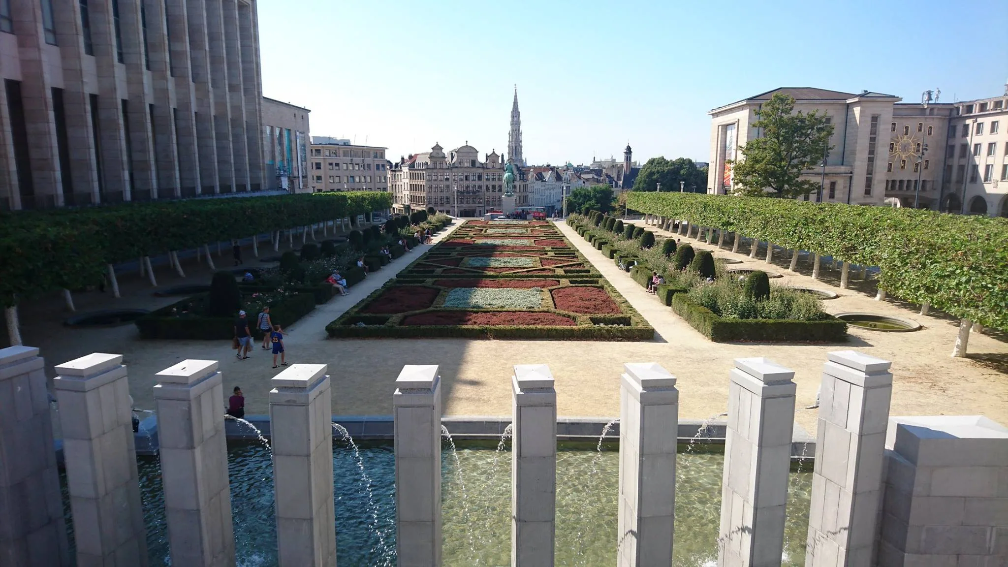 Formal gardens and city buildings viewed from a Brussels terrace