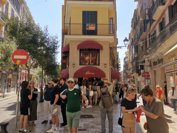 People exploring a narrow street in Palma