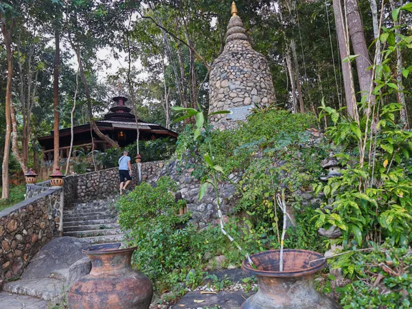 Stone steps and a small pagoda in a forest garden in northern Thailand