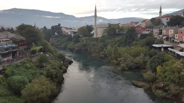 The Neretva winding past trees and old town buildings