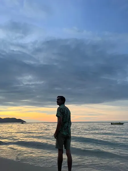 A traveller looking out to sea at dusk in Langkawi