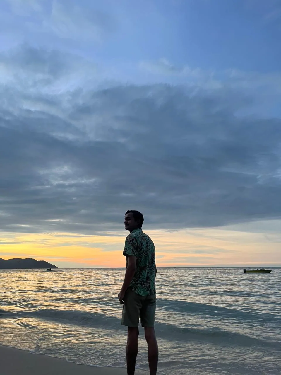 A traveller looking out to sea at dusk in Langkawi