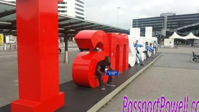 A traveller beside the large Amsterdam lettering