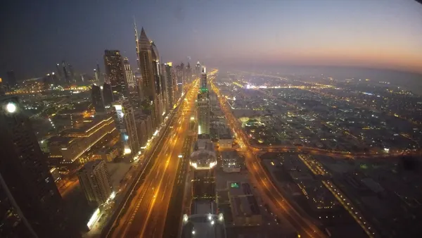 Dubai towers and an illuminated boulevard at dusk