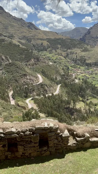 Terraced slopes and a winding road through a valley in the Cusco region