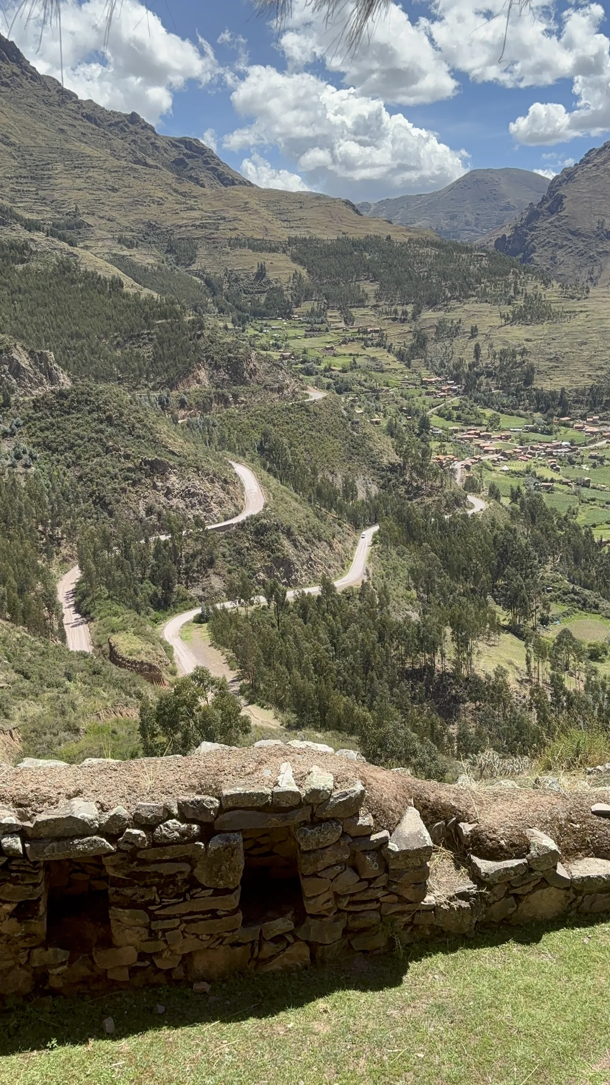 Terraced slopes and a winding road through a valley in the Cusco region