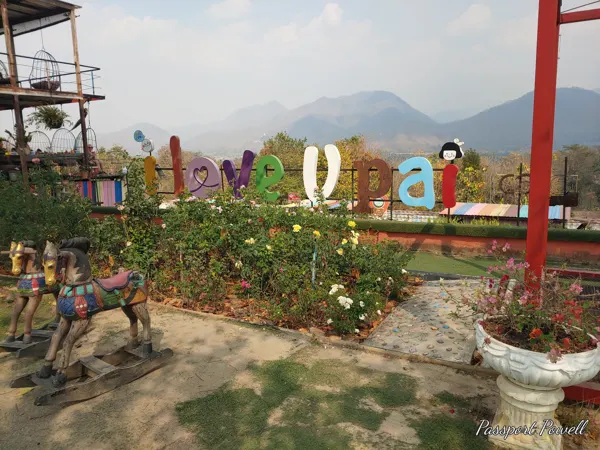 Colourful Pai lettering with mountains behind
