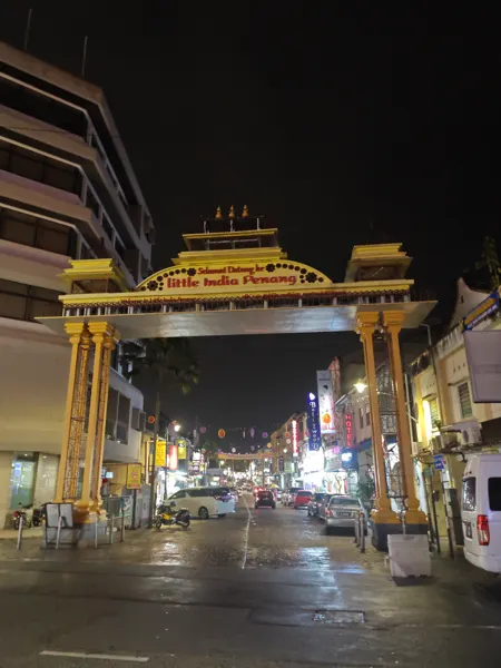 A lit gateway framing a street in George Town, Penang
