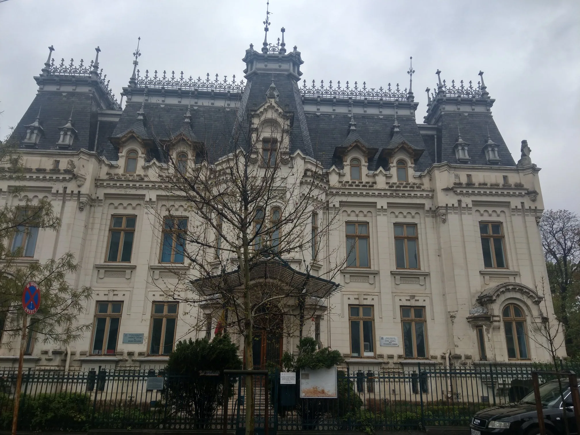 An ornate Bucharest building with a steep decorative roof