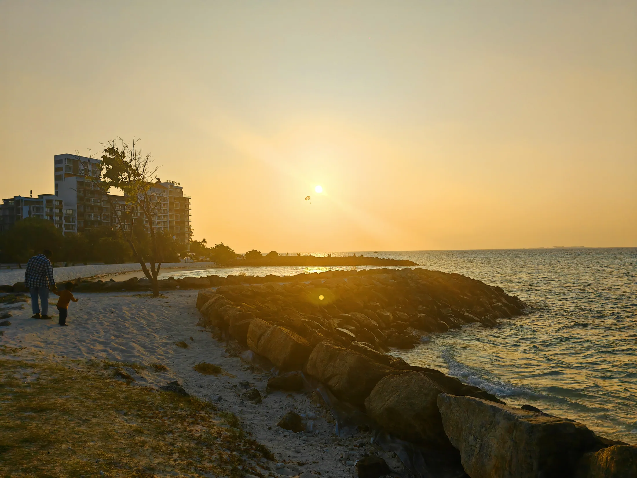 Golden evening light over the shoreline in Maafushi