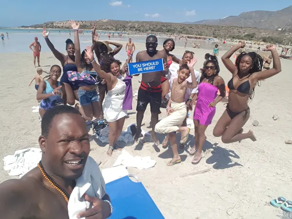 Travellers together on a bright sandy beach