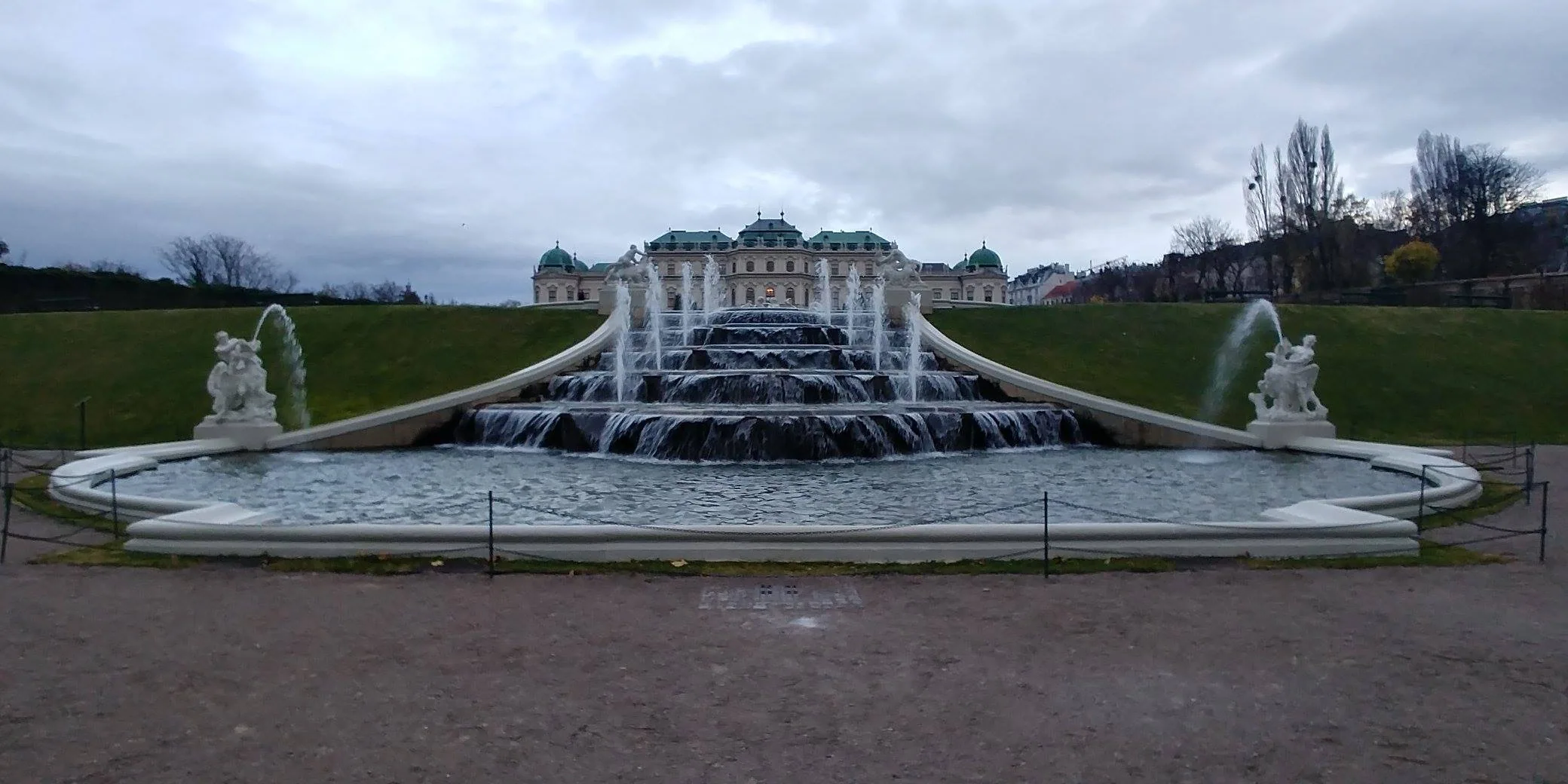 A broad cascade and sculptures in the palace gardens
