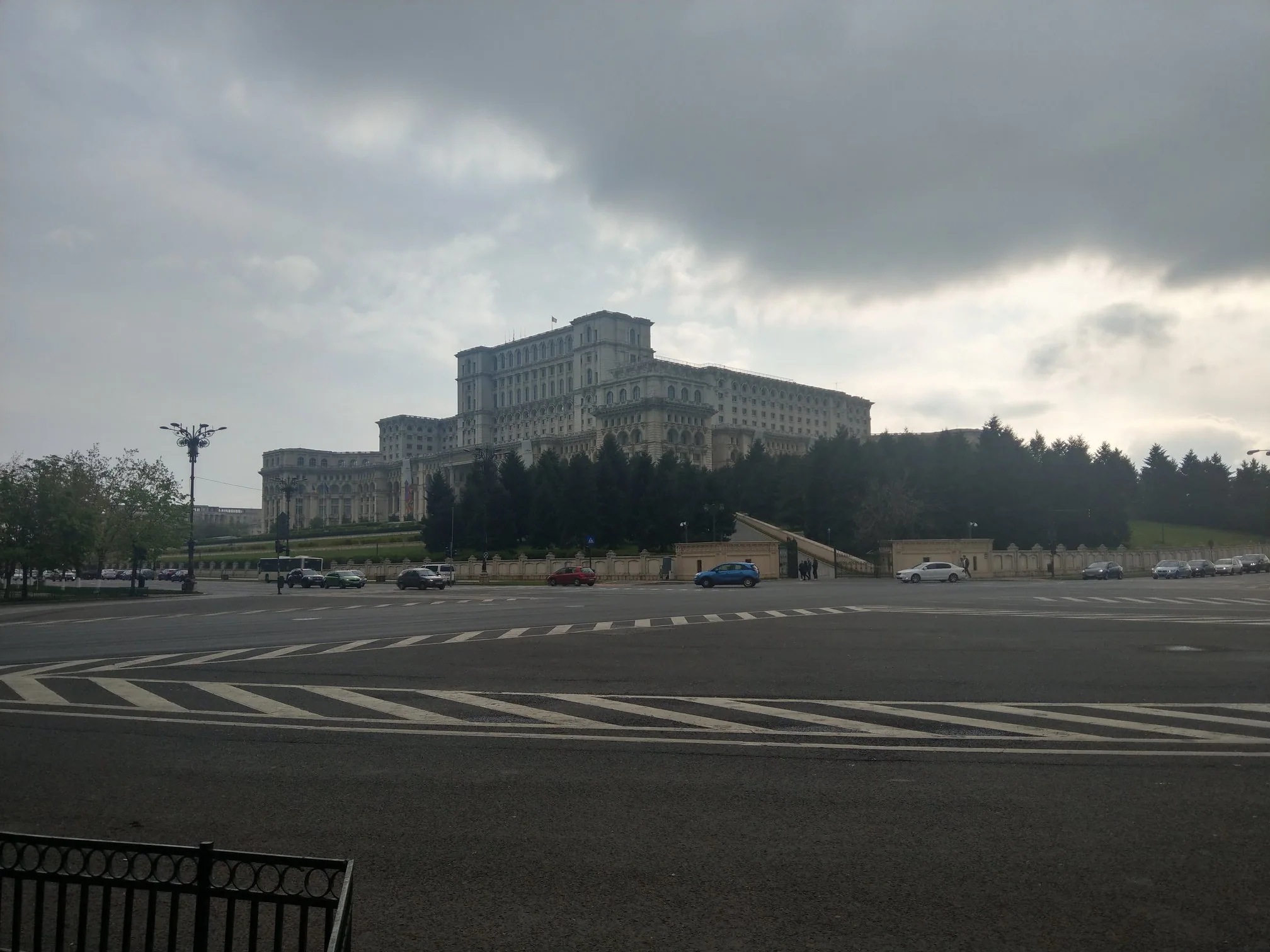 The Palace of Parliament beneath a dramatic cloudy sky