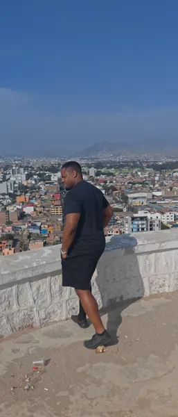 A traveller overlooking Lima from a hilltop