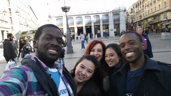 Travellers gathered in a busy Madrid square