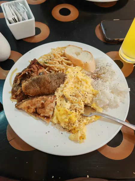 A plate of rice and grilled food during a stay in Metro Manila