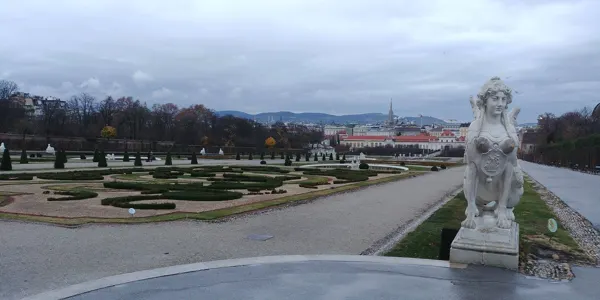 A stone sculpture overlooking the formal gardens