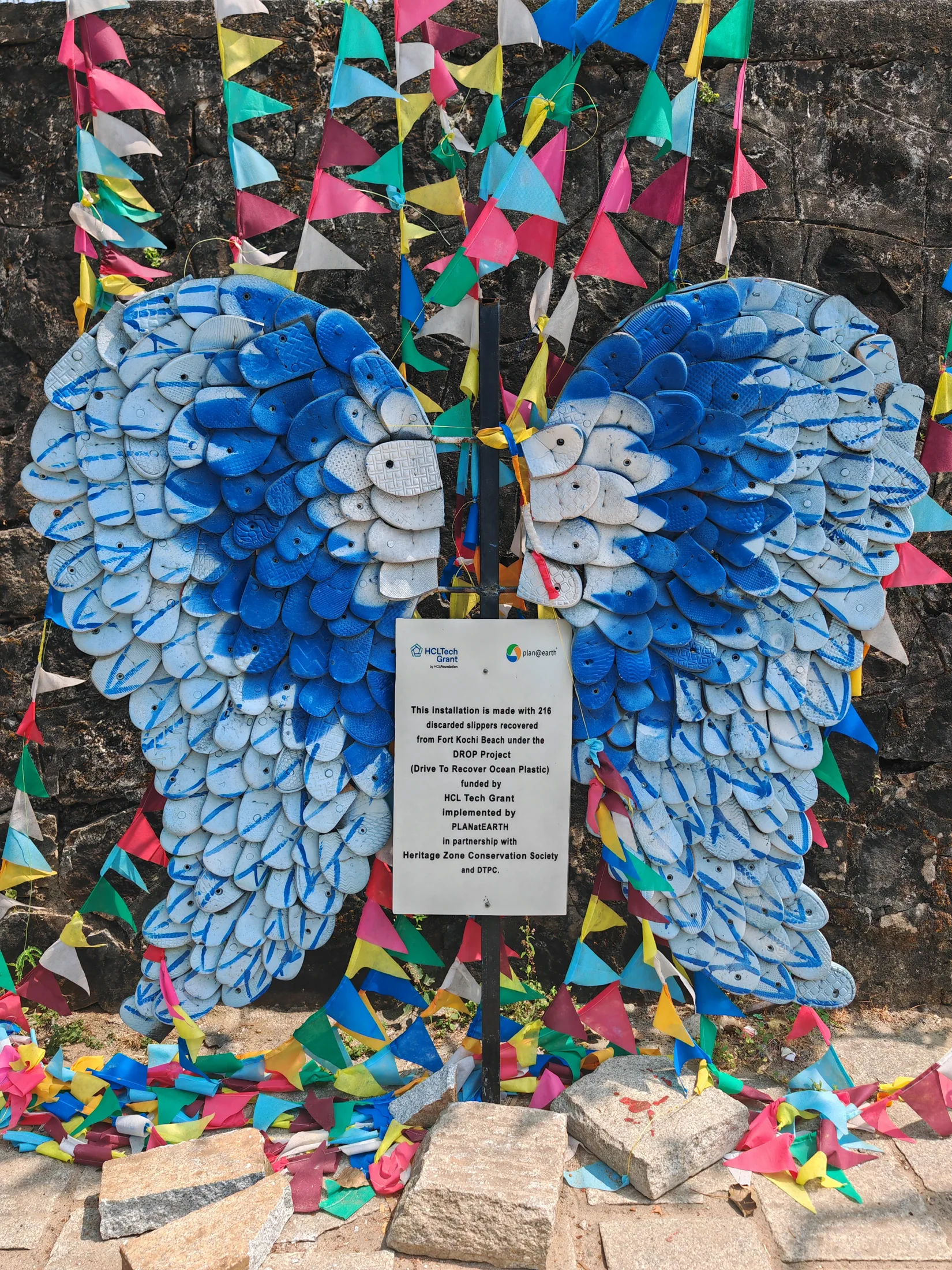 Colourful wing-shaped artwork and hanging paper decorations