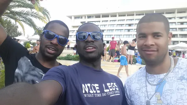 Travellers together outside a seaside hotel
