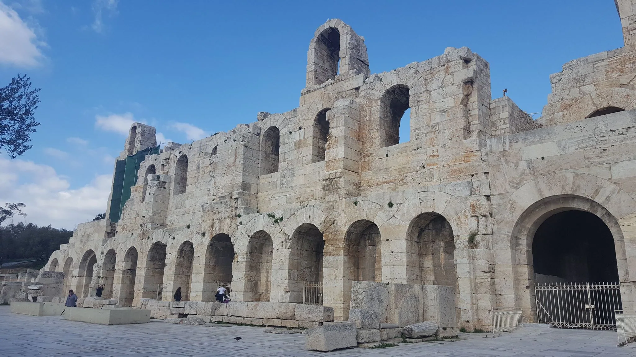 The stone arches of an ancient theatre beneath the Acropolis
