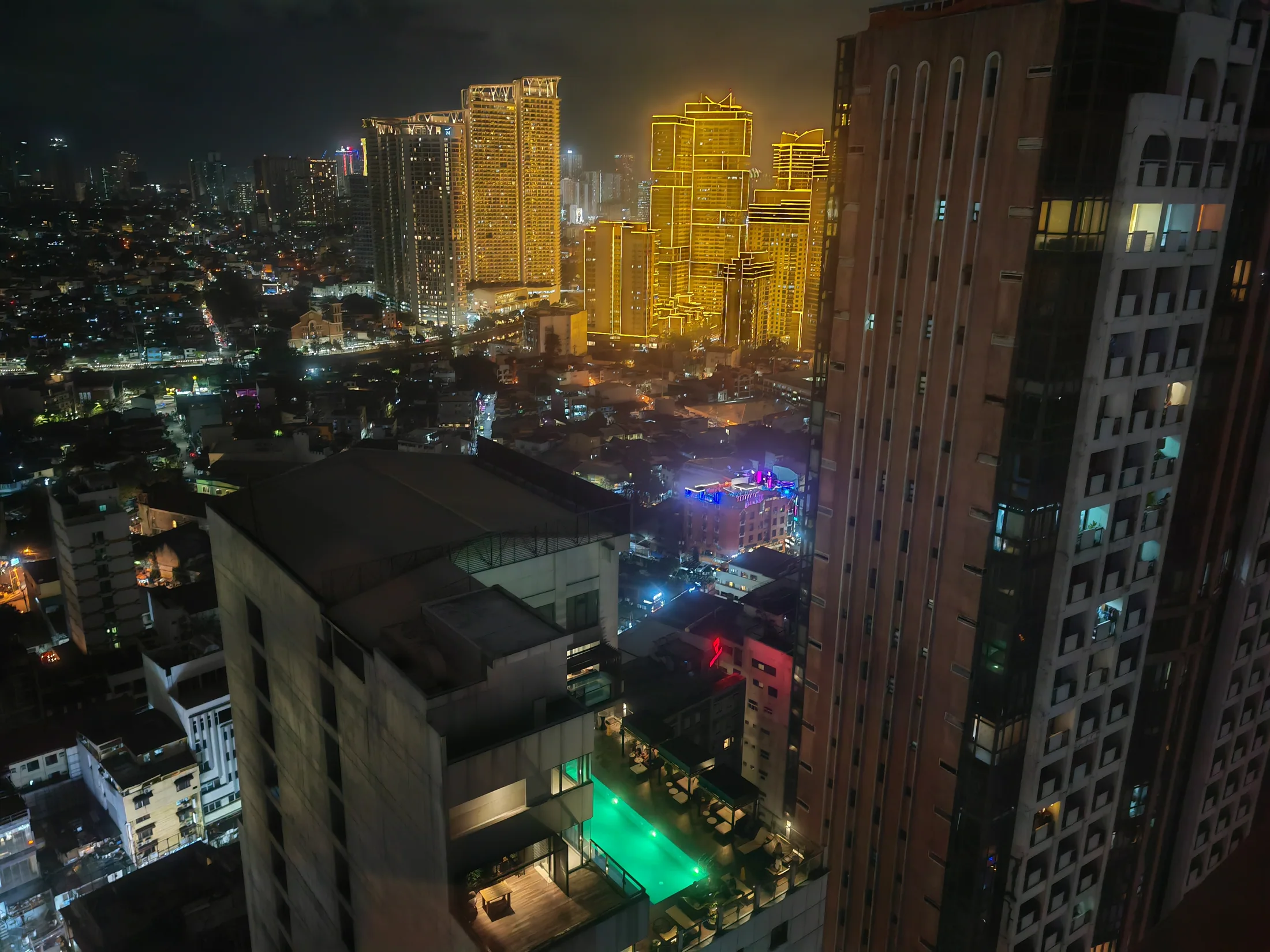 Illuminated towers above Metro Manila at night