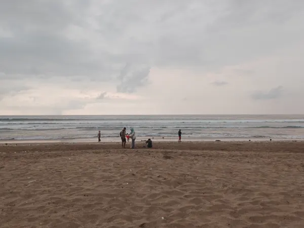 An overcast afternoon on a broad beach in Bali