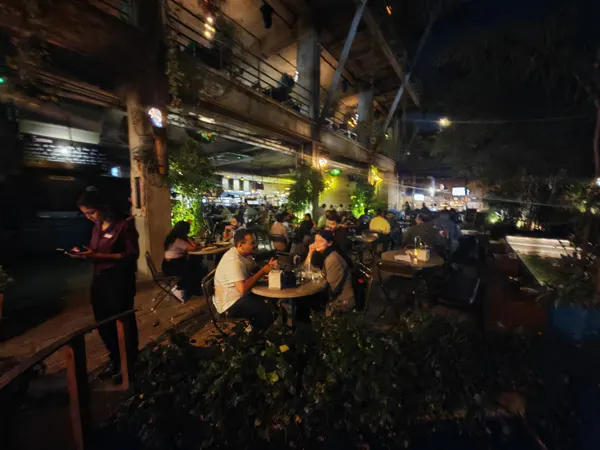 An open-air dining space beneath a timber roof