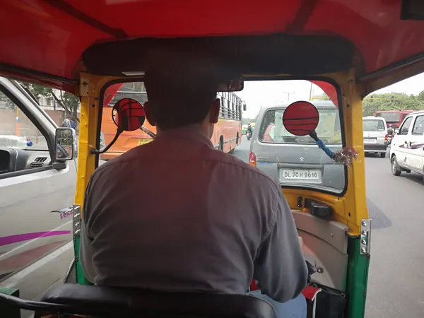A street view from the back of an auto-rickshaw