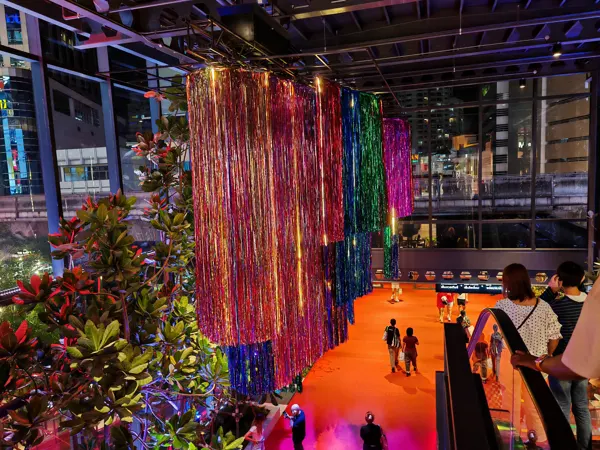 A colourful suspended art installation inside a Bangkok shopping centre