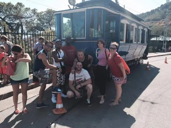 Travellers gathered beside a hillside funicular