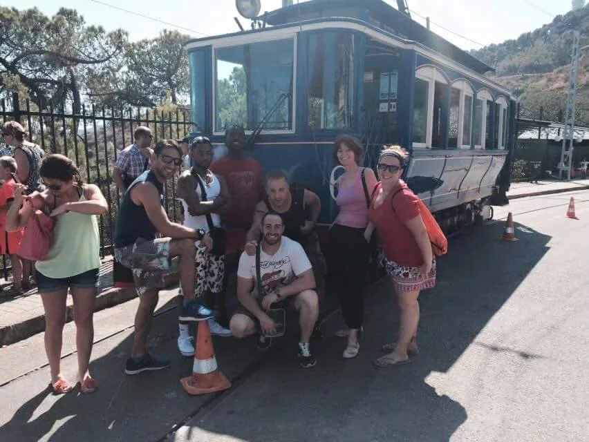 Travellers gathered beside a hillside funicular