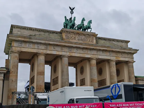 The Brandenburg Gate in Berlin, with event vehicles in the foreground