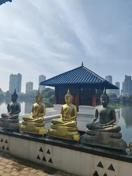 Buddha figures and a pavilion beside a lake in Colombo
