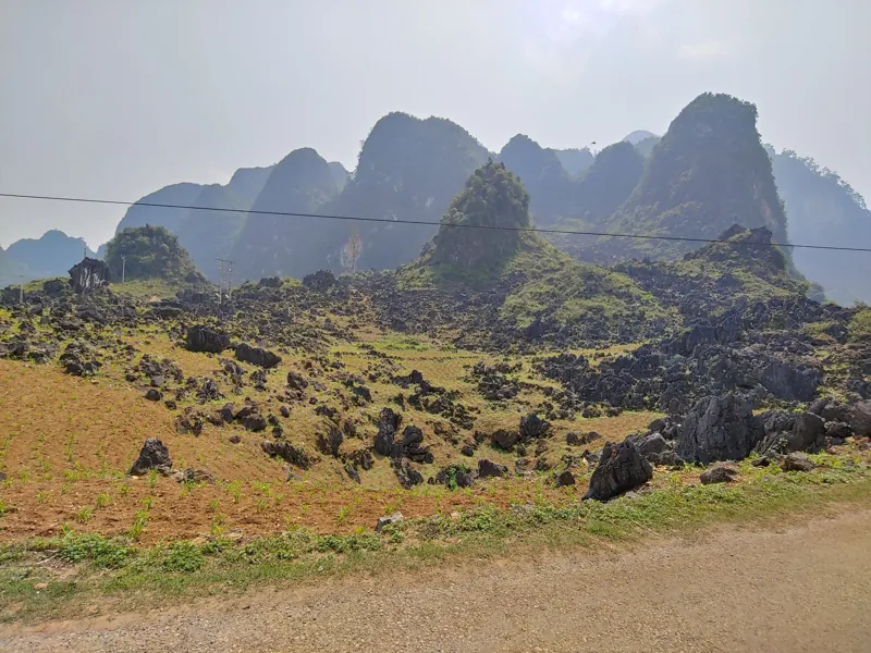 Sunlit karst peaks above a rocky green valley
